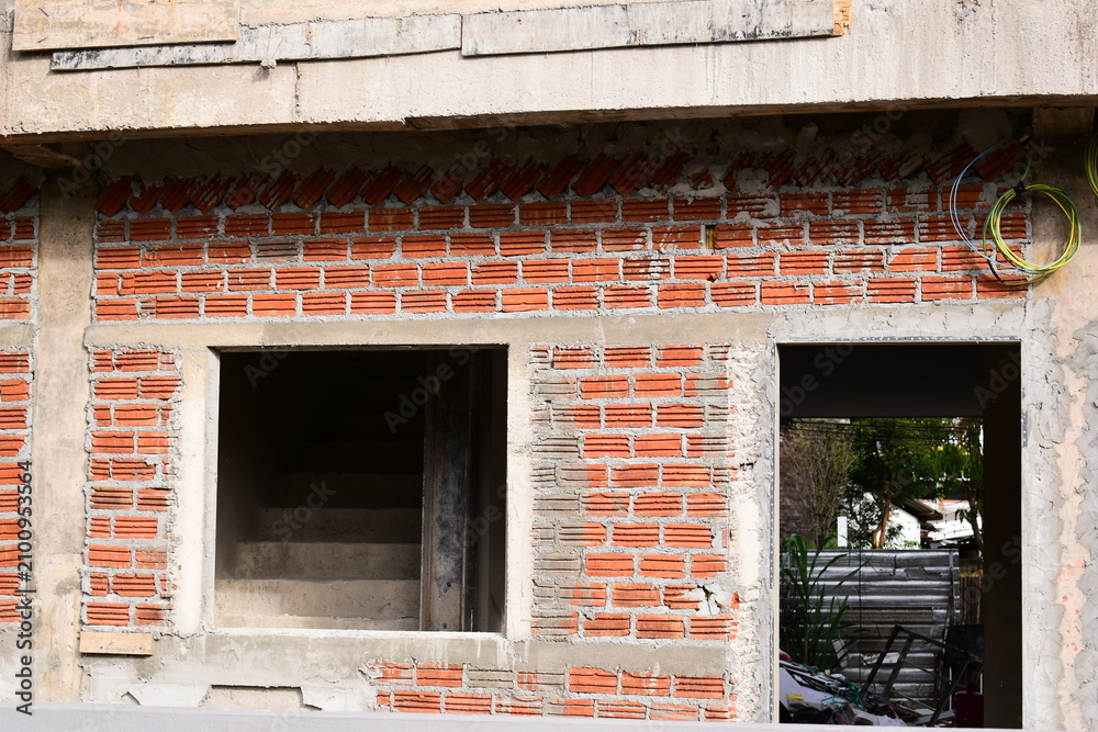 Obraz premium exterior view of brick house under construction with concrete structure