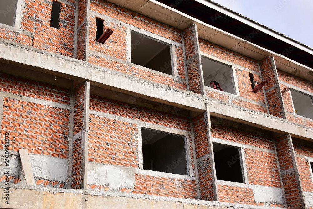 Obraz premium exterior view of brick house under construction with concrete structure