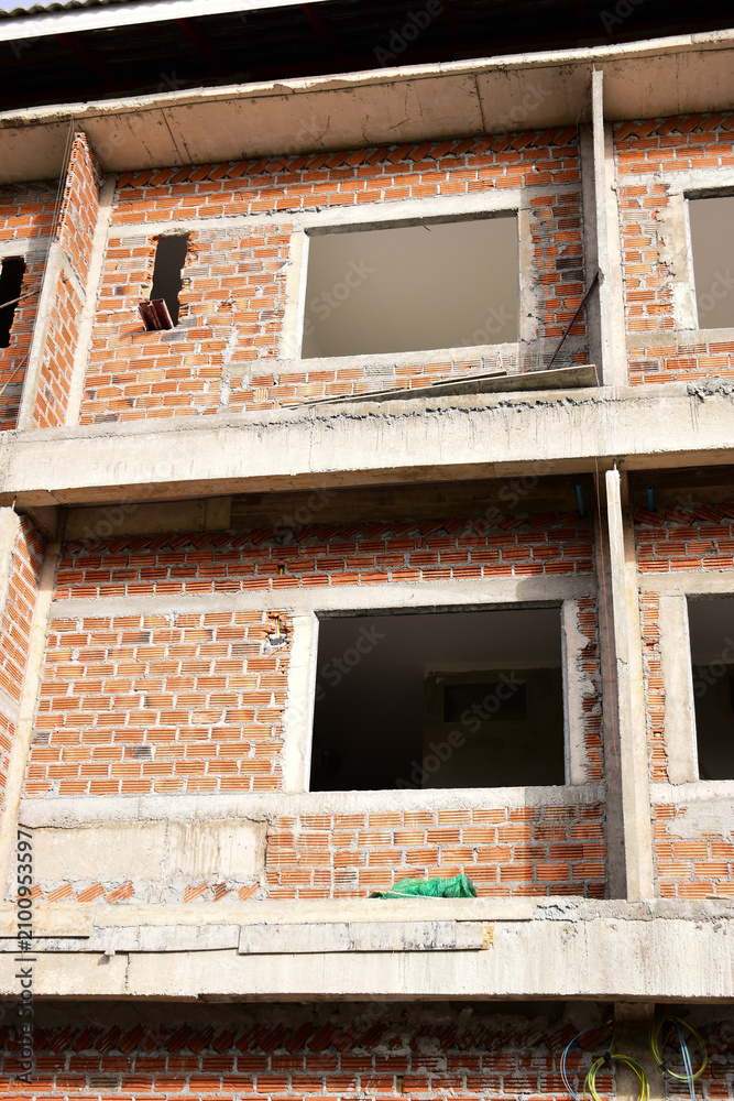 Obraz premium exterior view of brick house under construction with concrete structure