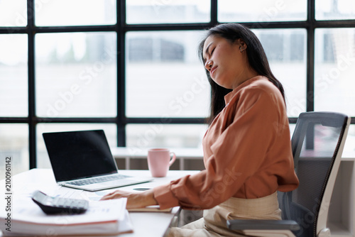 Fotografie Young asian woman sleeping at her office desk, facing fatigue and exhaustion fro