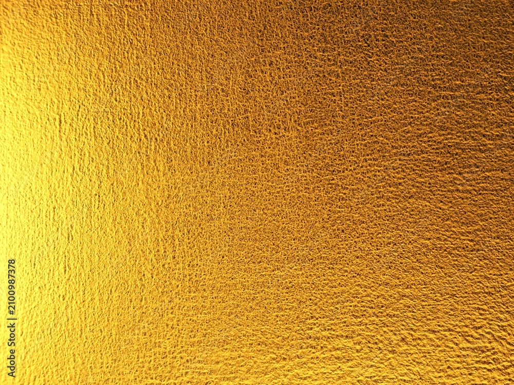 Naklejka premium ​Shiny gold textured background with rough metallic surface