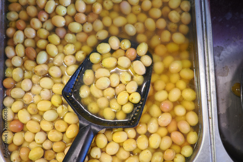 Photos Olives soaking in brine at a local market stand