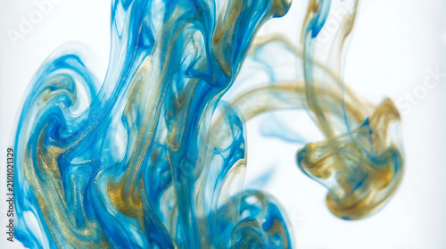 Abstract Blue and Gold Swirls: Mesmerizing blue and golden ink swirls in water, creating an abstract pattern reminiscent of smoke or nebulae, captivating with its fluid motion and rich colors.