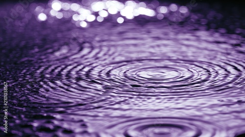 Deep purple water ripples with bright bokeh spots.