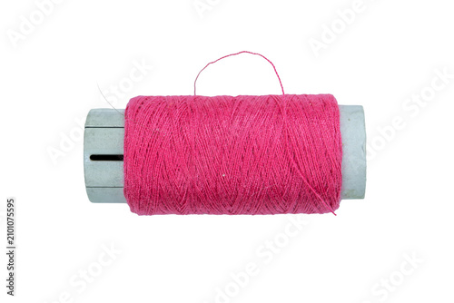 Fuchsia pink cotton thread spool on a transparent background for textile design.