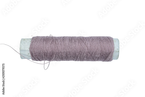 One spool of lilac colored thread for various sewing and craft projects on a transparent background.