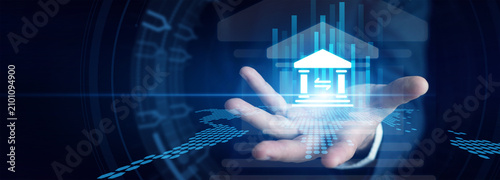 Fotografía Investment banker shown by tracking real-time global Banking trends and stock market fluctuations on multiple glowing screens in a financial hub