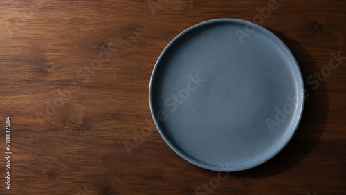 Minimalist blue gray plate on wood with handcrafted texture and warm natural lighting