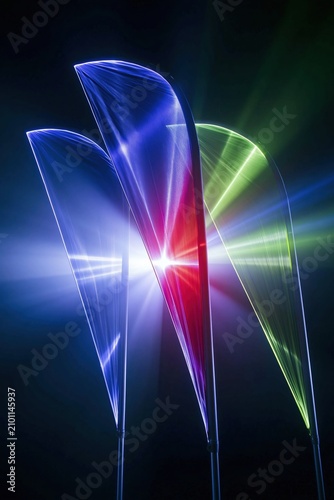 Three glowing feather banner flags with arched tops on a dark background for outdoor event signage and promotional brand display mockups