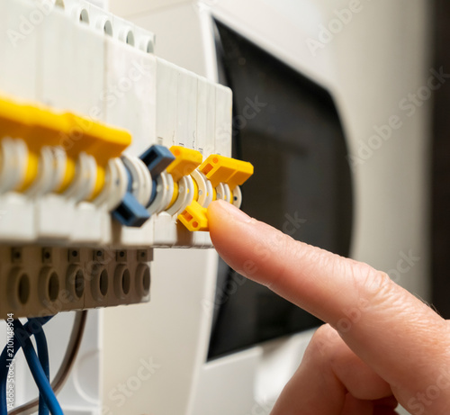 Принти на полотні Switching the circuit breaker in a control panel during home maintenance work in