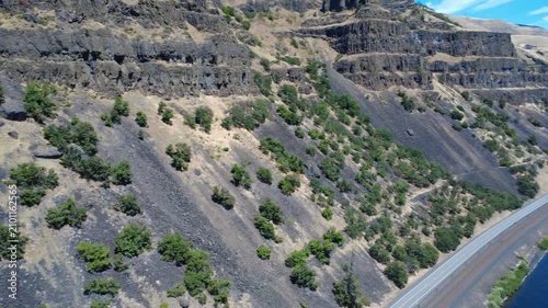  Pan right over Washington hills and highway along the Columbia River in the Gorge.
