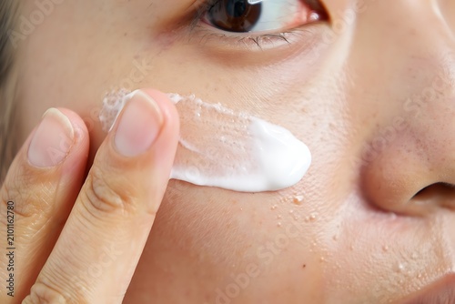 Applying moisturizer under the eye