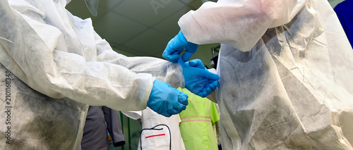 Portrait of doctors in clean suits with a protective mask and respirator.