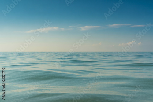 Calm ocean waves, serene sea surface, blue water background, peaceful landscape