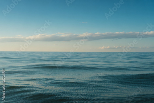 Calm ocean waves, serene blue water, peaceful sea landscape, sunny sky