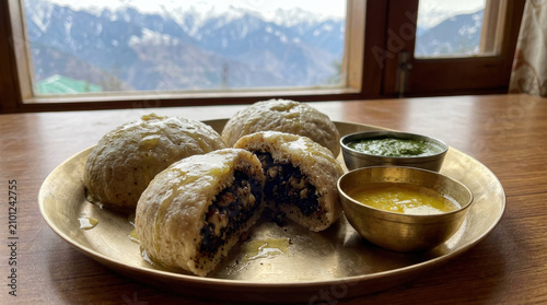 Himachali Siddu served with chutney and ghee on a brass plate with mountain view