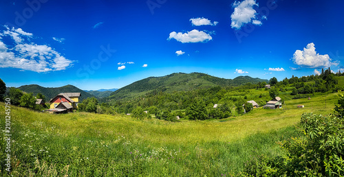 Sunny Carpathian peaks: green valleys and cloudy skies.