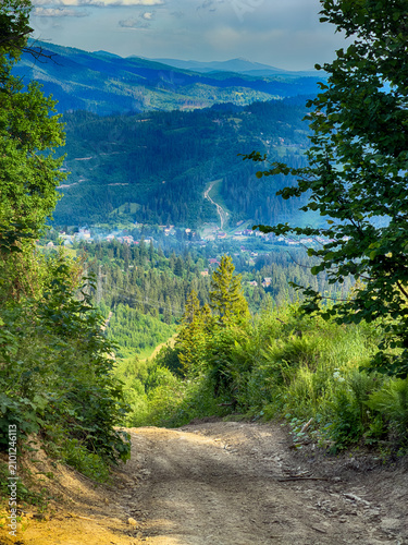 Sunny Carpathian peaks: green valleys and cloudy skies.