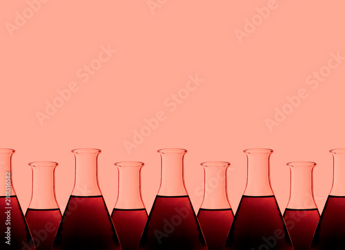 Row of test tubes with liquid, red background