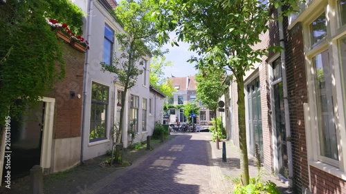 Sunny Cobblestone Street in Haarlem, Netherlands with Shops