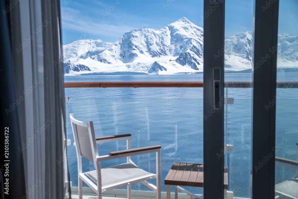 Fototapeta premium Antarctic polar expedition cruise ship cabin balconies offer views of snow-capped mountains and natural scenery.
