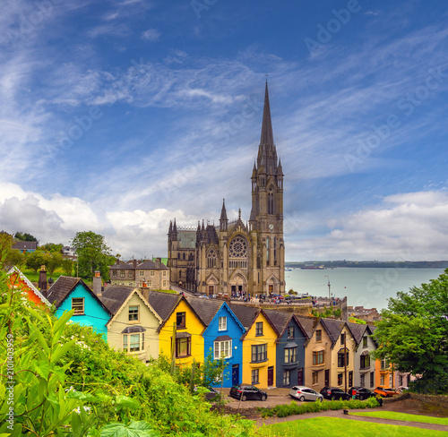 Fényképezés Lush gardens and picturesque row houses with and imposing gothic style cathedral