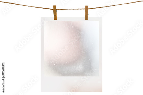 Blank photo frame hanging on a rope with a wooden clothespin. Isolated transparent PNG mockup.
