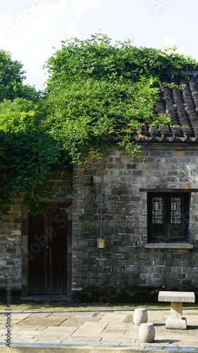 Chinese-style stone building covered in ivy