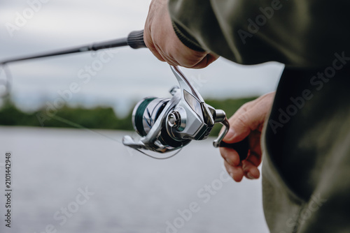 A spinning rod with a spinning reel in the hands of a fisherman