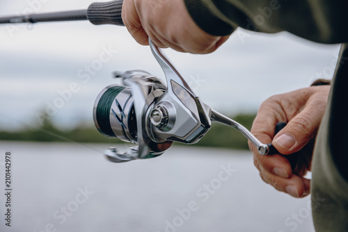 A spinning rod with a spinning reel in the hands of a fisherman