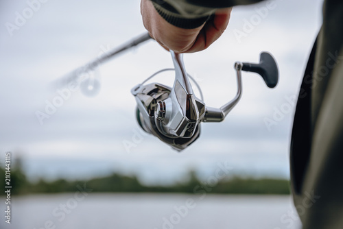 A spinning rod with a spinning reel in the hands of a fisherman