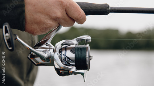 A spinning rod with a spinning reel in the hands of a fisherman