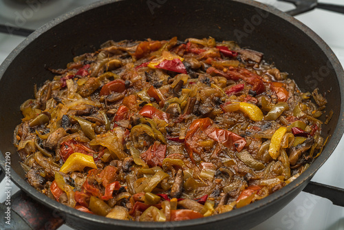 Obraz na płótnie Photo of a roasted vegetable stew in brightly colorful colors on black frying pan