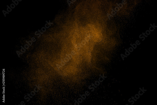 Abstract brown dust particles floating in the air on black background, creating a dynamic powder cloud with fine particle dispersion, motion effect, cinematic texture, and high speed freeze action.