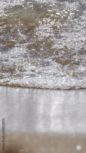 Sea waves splashing on sunny day, vertical video
