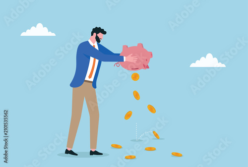 Foto Businessman emptying piggy bank as coins fall representing financial loss saving
