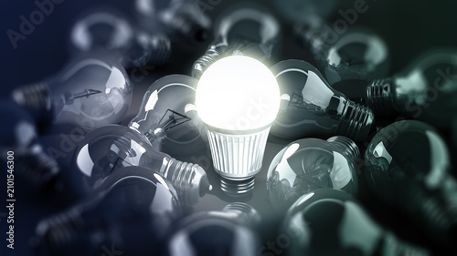 Принти на полотні Energy efficient light bulb among standard light bulbs