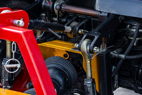 Agricultural tractor rear hitch linkage with cardan shaft drive. Modern farm machine power take off transmission coupling mechanism with technical transport engineering equipment details.