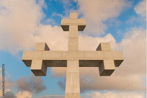 Принти на полотні Front view of huge stone cross monument against warm white clouds, located on the mountain over Gonio town near Batumi, Georgia