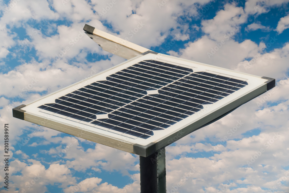 Obraz premium Solar panels against white clouds in the blue sky - close up view. Renewable energy, ecological, alternative source of electricity, and technology concept