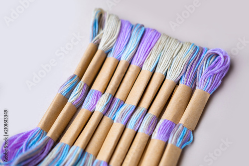 Quadro su tela Close-up colorful embroidery floss skeins with rainbow gradient transitions, cot
