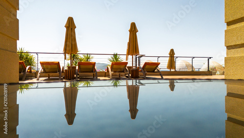 Luxury Poolside Loungers with Sea View and Reflection at Resort