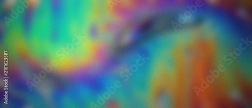 Fotografie Granulated iridescent oil film dynamically swirls on water, revealing psychedelic color shifts and a captivating metallic sheen