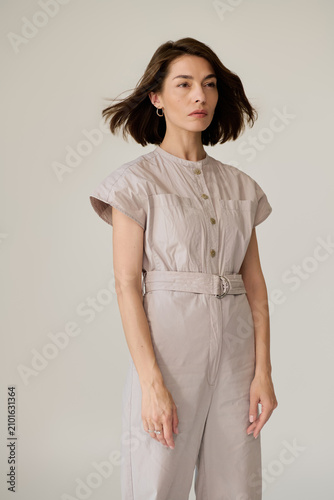 Canvastavla Chic fashion moment captured as a stylish woman poses with confidence in neutral
