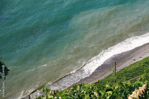 a view of the sea and the waves crashing against the shore