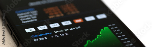 Bild auf Leinwand Rising Brent Crude oil chart and energy commodity data on smart phone screen