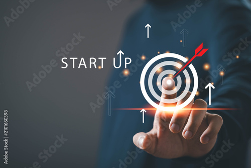 фотографія Startup business concept with hand touching target icon and upward arrows on dig