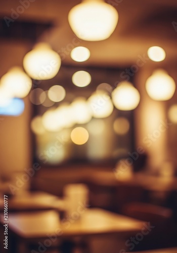 Defocused background of a warm, inviting cafe or restaurant interior featuring vibrant bokeh lights and soft atmospheric illumination, orange, comfort, background