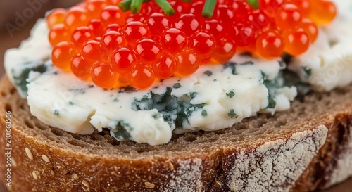 Bright Red Caviar on Creamy Cheese Spread Over Rustic Rye Bread Close Up
