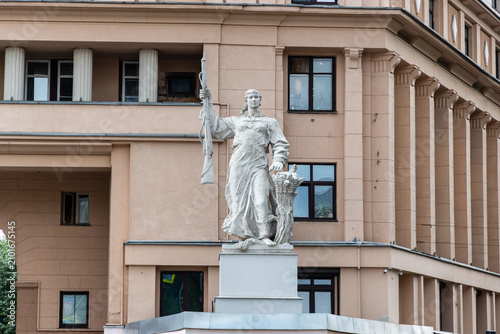 Photography Sculpture of a Soviet peasant woman with a rifle and a sheaf of wheat on a histo
